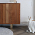 IKEA''s walnut veneer sideboard from the Stockholm series with brass furniture legs.